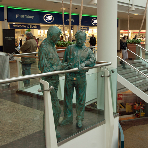 The Architects - two full size upright figures inside the Mall, in bronze effect GRP, by Aden Hynes.